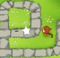 A Dart Monkey popping a Bloon with their dart